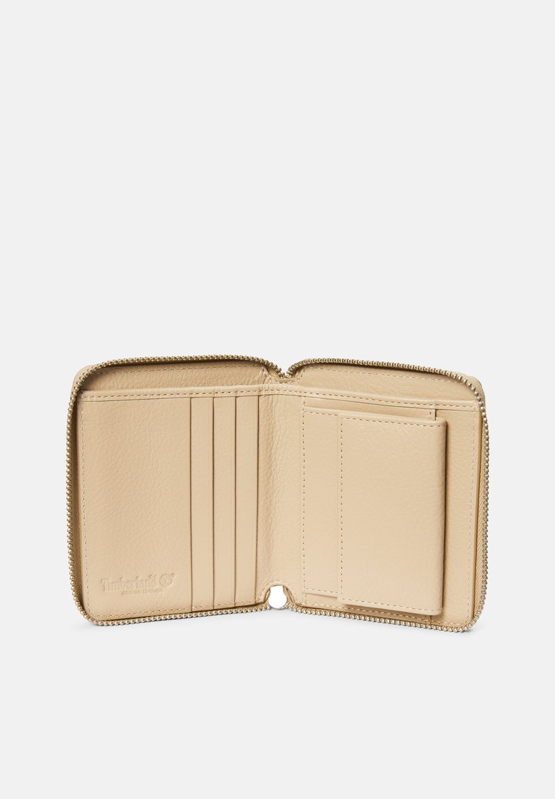 Portafoglio in pelle beige con chiusura a zip, dotato di cinque slot per carte, uno slot per ID e logo impresso, che mostra una texture liscia.