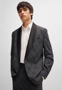 Black and gray plaid suit jacket with satin shawl lapel, featuring a subtle logo pattern, single button closure, and side pockets.