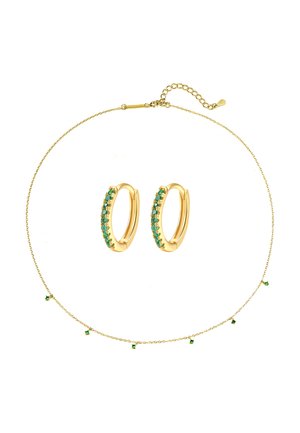 Gold hoop earrings with small green gemstones paired with a delicate gold chain necklace featuring evenly spaced green gemstone charms.