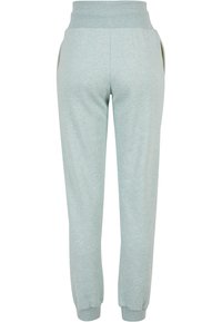 Ljusblå sweatpants med en mjuk textur, elastiskt midjeband och ribbad mudd. Har sidofickor och en avslappnad passform.
