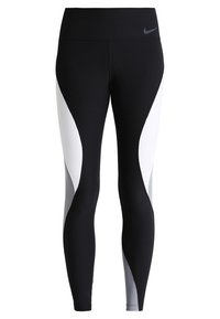 Leggings sportivi in bianco e nero con vita alta, caratterizzati da un design color block curvo e un piccolo logo grigio sulla vita.
