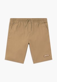 Béžové šortky vyrobené z lehké látky, s elastickým pasem, šňůrkou, bočními kapsami a hnědým logem Levi's na lemu.