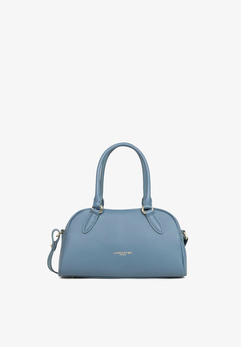Sac à main Lancaster Paris bleu avec deux poignées et une bandoulière amovible, présenté sur fond blanc.
