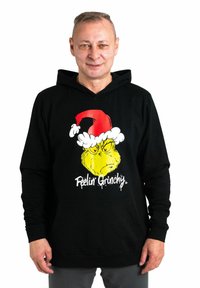 Felpa nera con un grafiche del Grinch che indossa un cappello di Babbo Natale rosso. La scritta recita "Mi sento Grinchoso". Realizzata in tessuto misto cotone, con tasca anteriore.