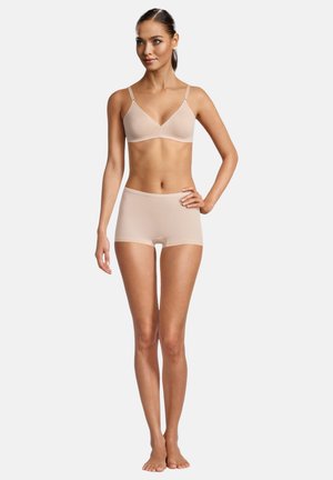 Helles beige Bralette- und Shorts-Set aus glattem Stoff, mit dünnen Trägern und nahtlosem Design.