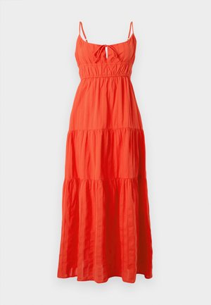Maxi dress in bright orange fabric, featuring thin straps, a front tie detail, and tiered ruffles. Lightweight, textured cotton blend.