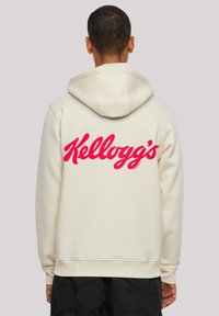 Cream-colored hoodie with a large pink "Kellogg's" logo on the back. Features a drawstring hood and ribbed cuffs and hem.