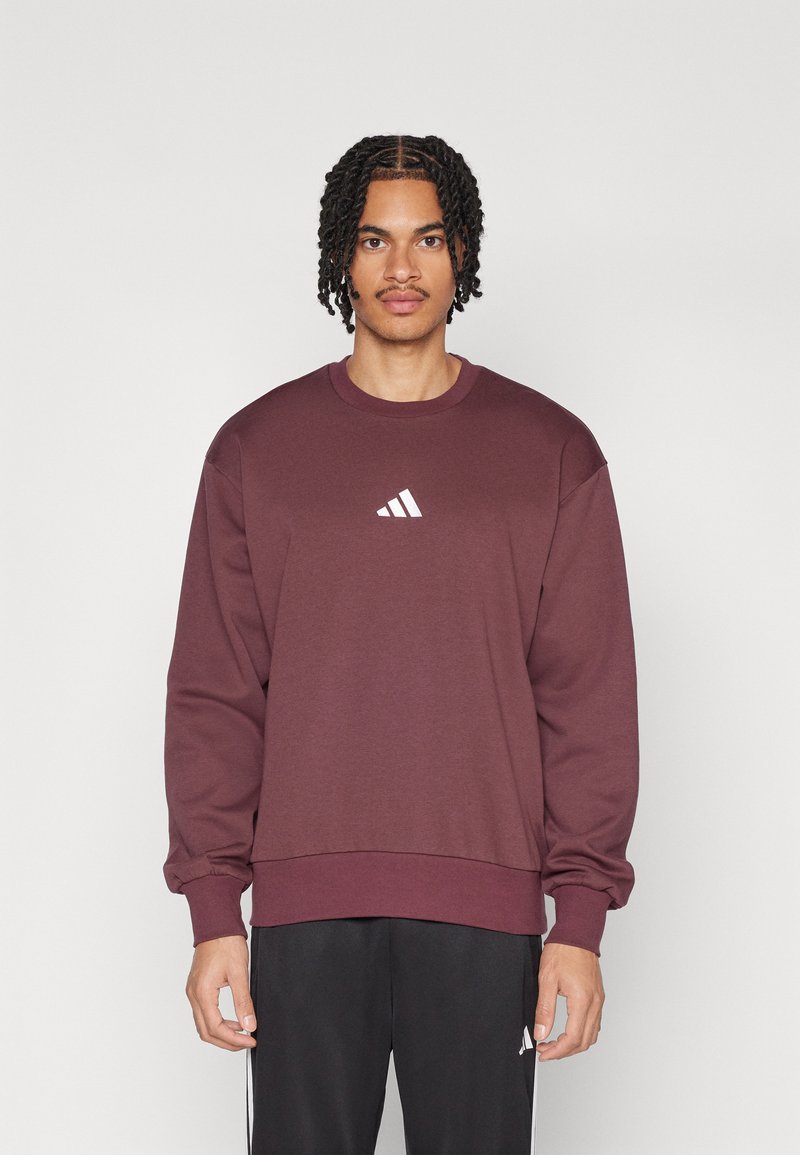 Bordeaurode sweatshirt van een katoenmix met lange mouwen, geribbelde mouwen en een ronde hals met een wit Adidas-logo op de borst.