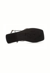 Black shoe sole with a textured surface, featuring engraved floral patterns. Strap and buckle detail visible on the side.