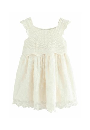Weißes Kleid mit einem gehäkelten Oberteil mit gewellten Kanten und einem Spitzenrock, der mit Blumenmustern verziert ist. Weicher, leichter Stoff.