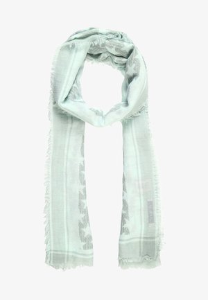 Lysegrønt tørklæde med frynset kant, der har et subtilt stjernemønster og vævede stribede kanter, løst bundet med enderne hængende ned.