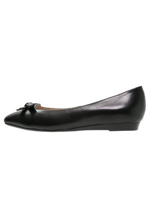 Chaussure plate en cuir noir avec bout pointu, petit nœud sur le devant, et talon compensé bas.