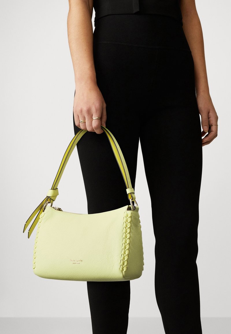 Bolso de mano de cuero amarillo con un detalle trenzado, con una doble correa en amarillo y negro. Textura lisa con un cierre de cremallera.