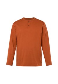 Långärmad skjorta i bränt orange, tillverkad av bomull. Har en rund halsringning med en knappslå och två mörka knappar, slät textur.