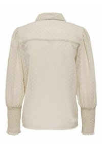Kremowa bluzka z teksturalnym wzorem w kropki, z zapięciem na guziki z tyłu oraz bufiastymi rękawami z marszczonymi mankietami. Lekki materiał.