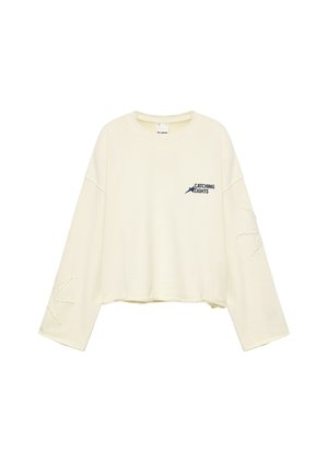 Kremfarvet sweatshirt med lange ærmer med teksten "Catching Lights" og en stjernemotiv på brystet samt syede stjernedesigns på begge ærmer.