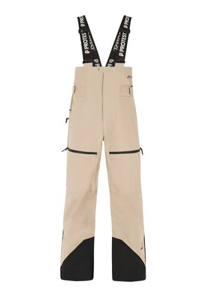 Beige skibroek met zwarte accenten, verstelbare bretels, meerdere met rits gesloten zakken en een brede, flare onderkant voor gemakkelijke beweging.