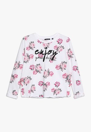 Witte longsleeve met roze rozenpatronen en zwarte tekst "enjoy your day" over de borst, ronde halslijn en details met zijslits.