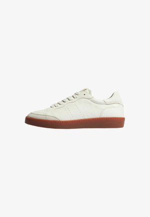 Sneaker bianco in pelle con texture liscia, punta arrotondata, cinque occhielli e suola in gomma marrone. Presenta una sottile dettagliatura perforata sui lati.