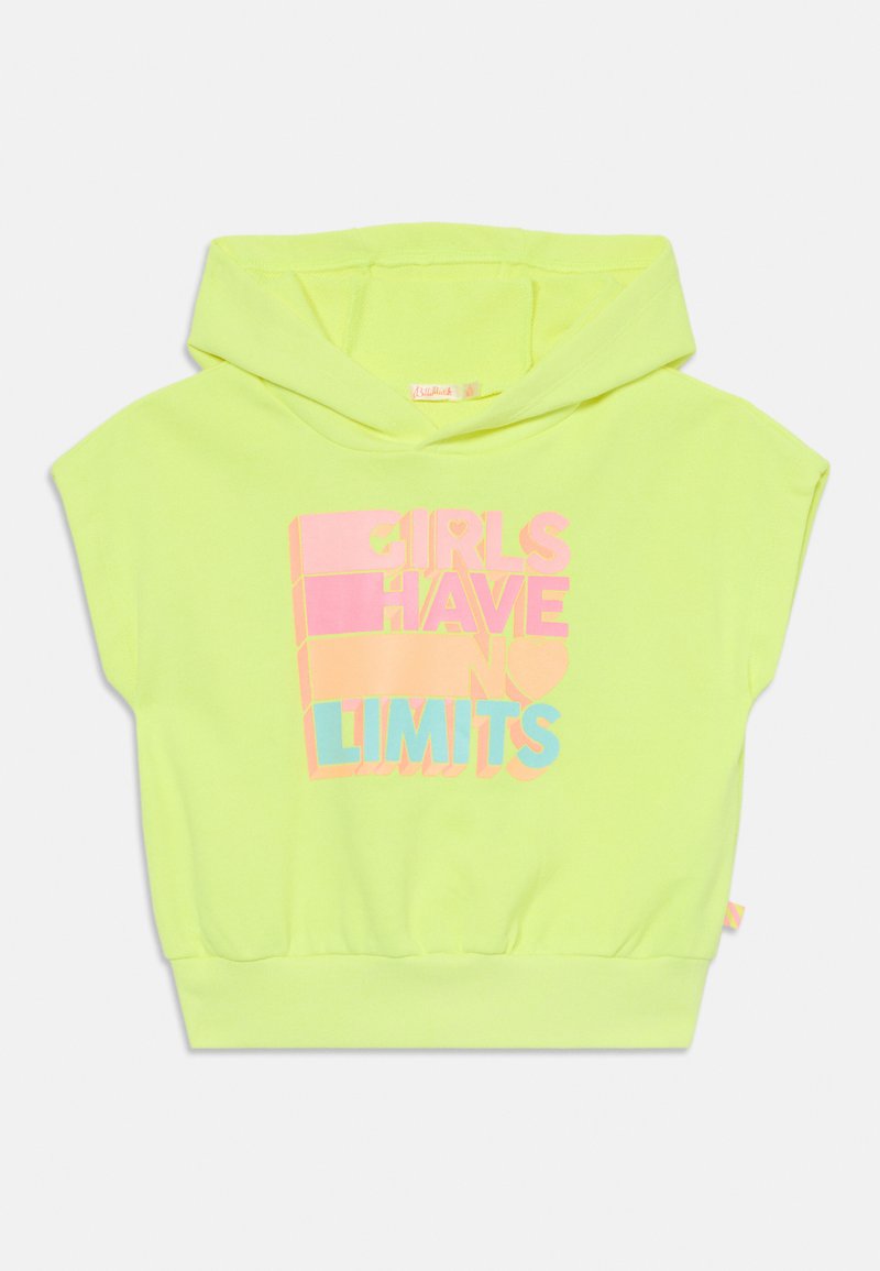 Neon gul jakke med korte ermer, med flerfarget tekst "JENTER HAR INGEN BEGRENSNINGER" i rosa, blått og lilla.