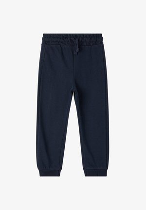 Granatowe dresy z elastycznym pasem i sznurkiem, zwężane nogawki oraz ściągacze na kostkach. Miękka, teksturowana tkanina bez wzorów.