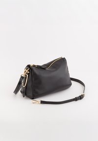 Czarna skórzana torebka na ramię o teksturowanym wykończeniu, z złotymi akcentami i zapięciem na zamek. Regulowany pasek dla większej wszechstronności.