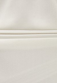White fabric with a textured surface, featuring a subtle grid pattern and a horizontal seam detail near the bottom.