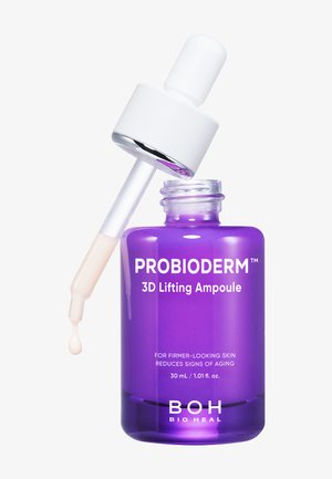 Flacon violet de PROBIODERM 3D Lifting Ampoule avec un compte-gouttes blanc libérant une goutte de sérum, produit de soin pour une peau plus ferme et la réduction des signes de l'âge.
