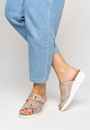 Taupe suede slide sandals with two adjustable straps and round hardware accents. Features a white wedge sole and textured footbed.