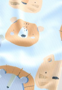 Light blue fabric with ribbed texture featuring cartoon bear faces in brown and cream hues, accented by minimal black facial details.