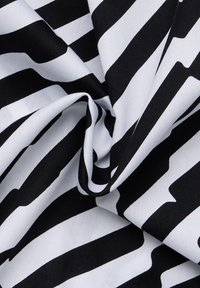 Black and white striped fabric with alternating thick and thin stripes, featuring a smooth texture and a slight sheen.
