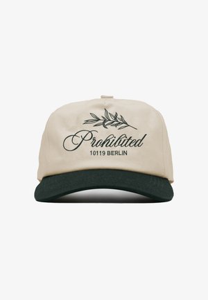 Beige en zwarte pet met de tekst "Prohibited 10119 Berlin" en een grafische afbeelding van een bladerrijke tak op het voorpaneel.