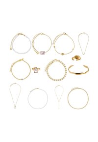 Collection of jewelry featuring gold and silver bracelets and necklaces. Notable designs include beads, chains, and a square accent stone.