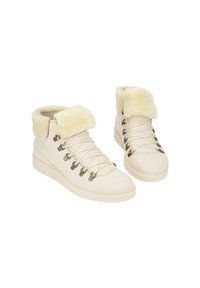 Beige ankle boots with a faux fur collar, lace-up design, textured surface, and metallic hardware accents, featuring a rubber sole.