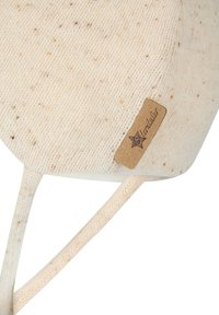 Close-up of a beige knit winter hat with light brown speckles and a small leather tag reading "Sterntaler" on a white background.