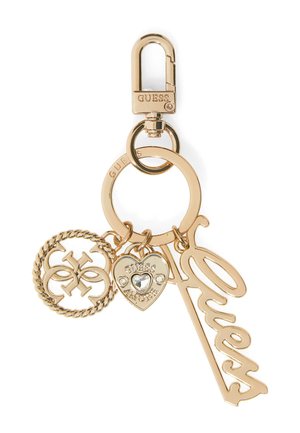 Porte-clés en or avec un fermoir, un anneau circulaire, un charme au design corde, un charme en forme de cœur avec un strass, et le mot "Guess" en script.