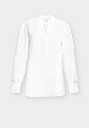 Balta blūze ar garām piedurknēm, V veida izgriezumu, joslas apkakli un pogām aizpogātām aprocēm, attēlota uz vienkārša gaiši pelēka fona.