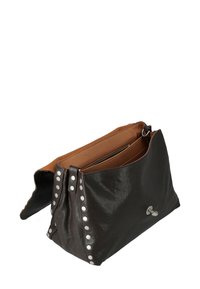 Borsa a mano in pelle marrone con borchie argentate lungo il lato, un ampio interno e una tasca con zip. Esterno morbido e testurizzato.
