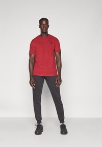 Puma SWEATPANTS  - Donji dijelovi trenirke - puma black