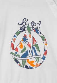 White garment featuring a circular design with floral patterns in red, blue, green, and yellow, accented by two black outline dogs on top.