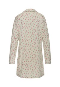 Langermet pysjamastrøye i myk beige stoff, dekorert med rødt og hvitt polkagrismønster over hele. Har krage og knappe Mansjetter.