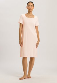 Pink short-sleeve dress with a square neckline. Made of soft fabric, falls just above the knee, smooth texture, minimalistic design.