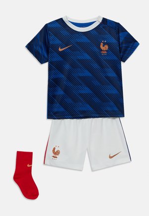 Blue and dark blue patterned soccer jersey, white shorts with red and blue stripes, red sock, all with bronze Nike logos and French Football Federation emblem.