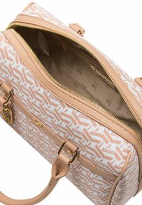 Beżowa i biała torebka w wzory z złotymi akcentami i zamkiem błyskawicznym. Wnętrze wyłożone jasnym materiałem. Posiada podwójne uchwyty i usztywnioną konstrukcję.