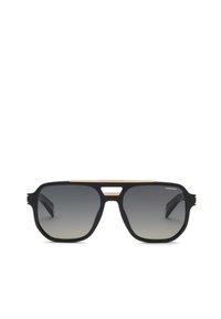 Lunettes de soleil noires style aviateur avec verres gris dégradés, détail pont doré et logo "Chopard" dans le coin droit du verre.