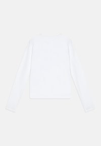 White long-sleeve top made from soft fabric, featuring a round neckline and a straight cut. The back design is plain with no embellishments.