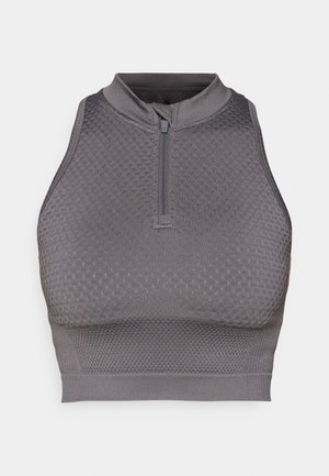 Crop top de sport gris avec col zippé, motif texturé, design ajusté et finition lisse au niveau de l'ourlet et des emmanchures.