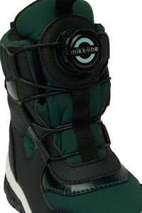 Black and green winter boot featuring a textured synthetic upper, adjustable lacing system, and a prominent circular logo on the side.