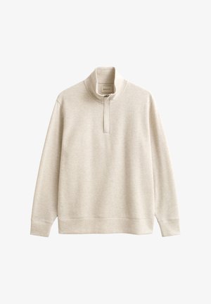 Világos bézs pulóver magas nyakkal, fél cipzáras záródással, hosszú ujjal és bordázott mandzsettákkal. Puha, texturált anyag.