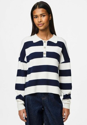 Pull en tricot rayé navy et blanc avec un col et trois boutons décoratifs. Doté de manches larges et d'une coupe décontractée.